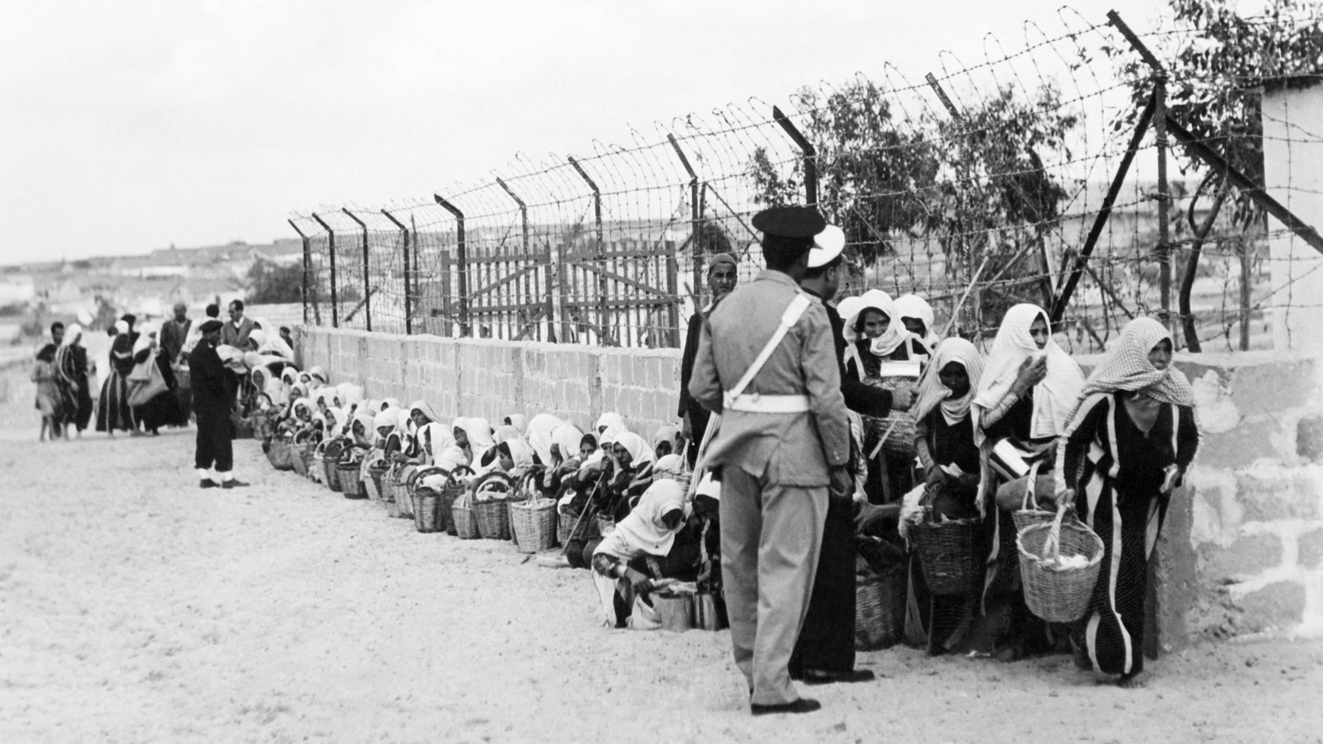 Palestinian refugees queue for food distributed by UNRWA at a camp in Gaza, 9 November 1956 (AFP/Rene Jarland)