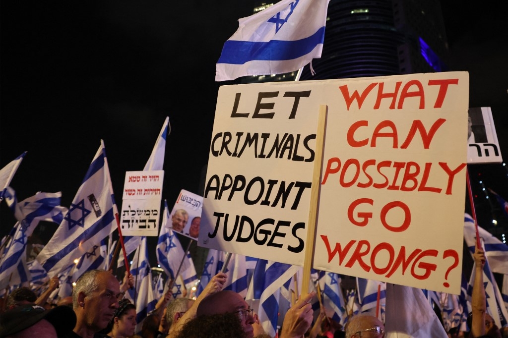 People protest against the hard-right government's controversial judicial reform plans in Tel Aviv, 10 June 2023 (AFP)