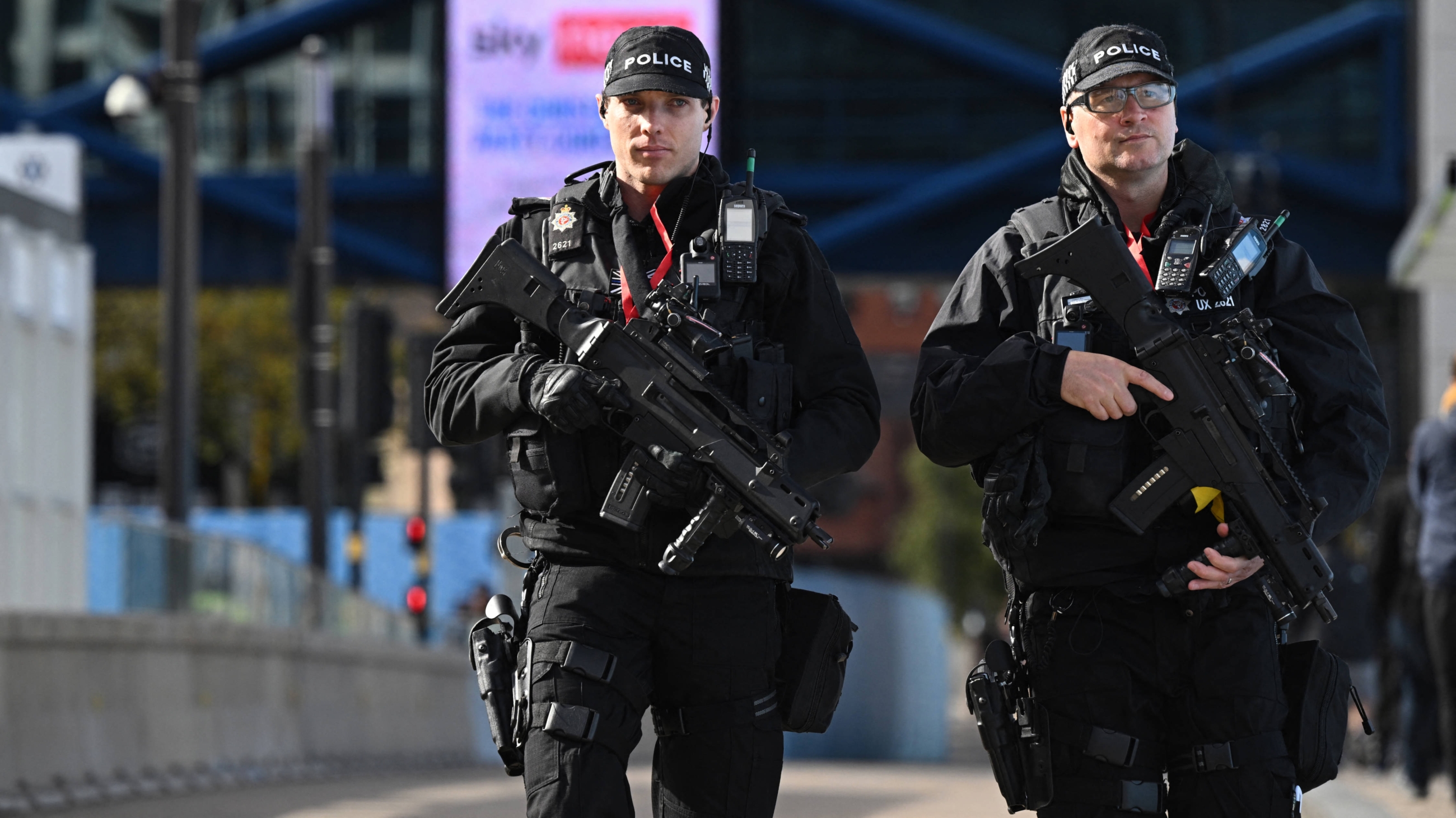 Armed police patrol outside the venue on the opening day of the annual Conservative Party Conference in Birmingham, central England, on 2 October 2022 (AFP)
