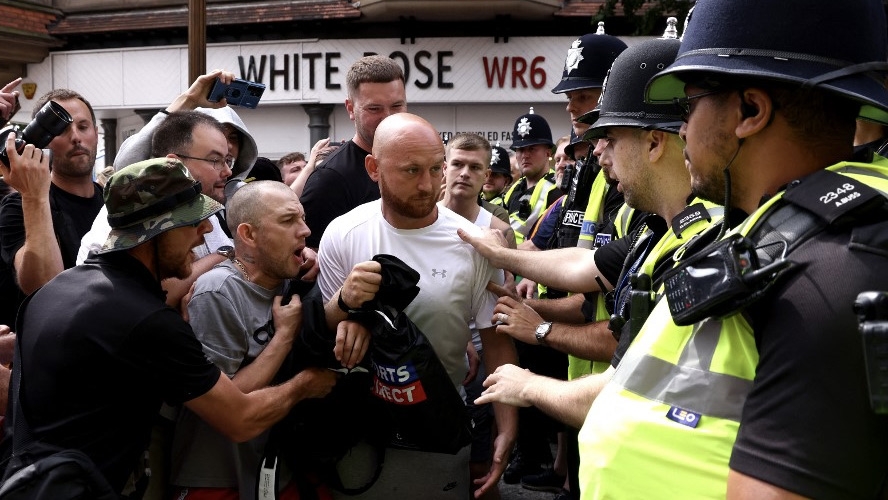 Protesters gather in Nottingham on 3 August 2024 for an 'Enough is Enough' demonstration held in reaction to the fatal stabbings in Southport (Darren Staples/AFP)