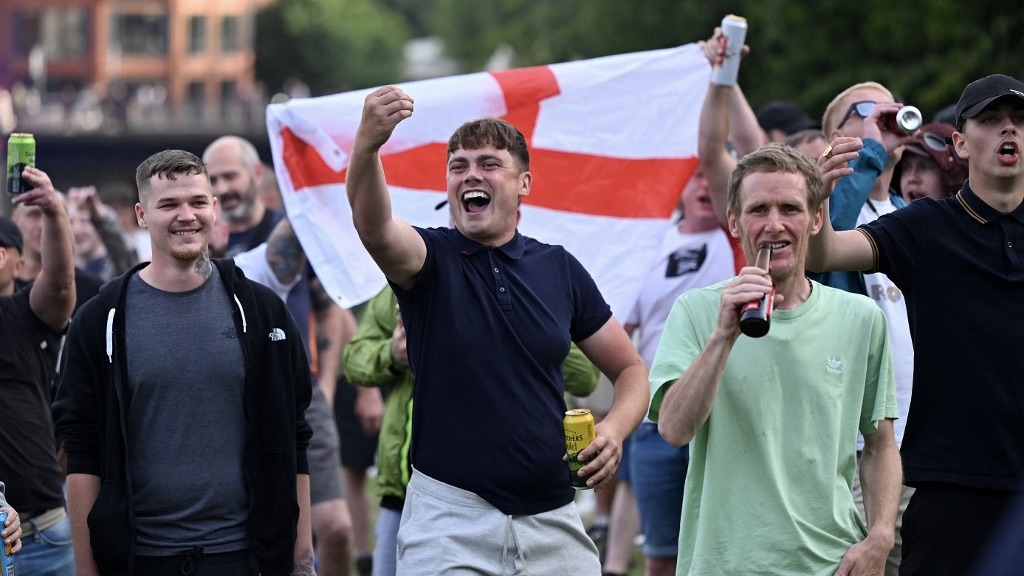 Protesters gesture at police officers during the 'Enough is Enough' demonstration called by far-right activists in Bristol on 3 August 2024 (Justin Tallis/AFP)