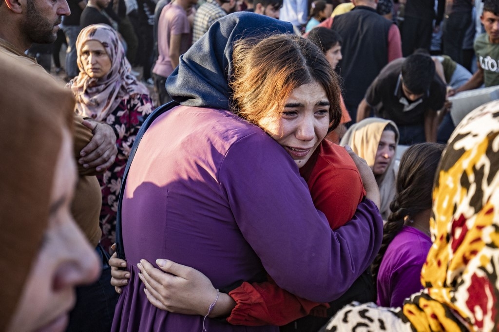 Relatives at the funeral of members of the Kurdish Asayish security forces, killed in a Turkish drone strike, Amuda, northeastern Syria, 7 October 2023 (AFP)
