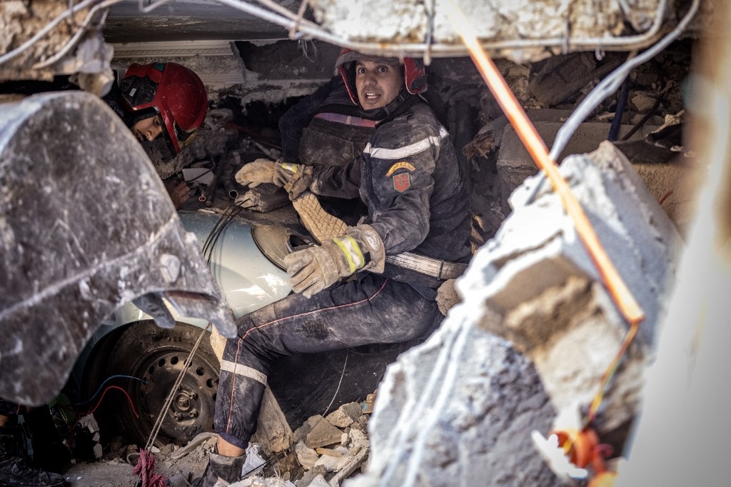 Rescue workers search for survivors in a collapsed house in Moulay Brahim, al-Haouz province, on 9 September 2023, after Morocco was struck by its deadliest earthquake in decades (AFP)
