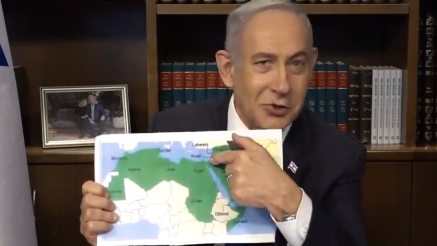 Benjamin Netanyahu points to a map of the Middle East and North Africa in a video filmed in his office (X)