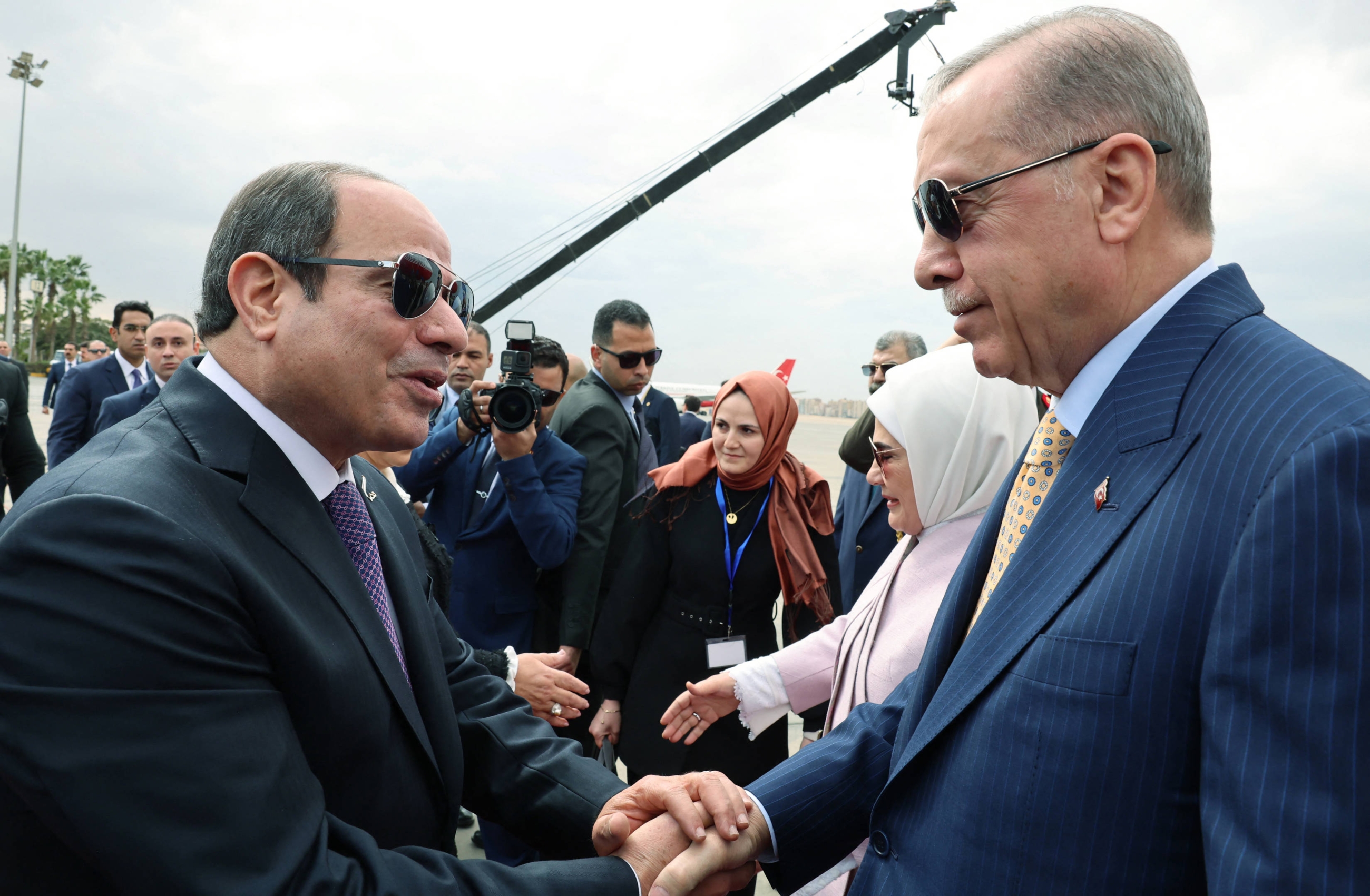 Egypt's President Abdel Fattah el-Sisi (L) greets Turkey’s President Recep Tayyip Erdogan at Cairo airport, 14 February 2024 (Turkish Presidential Press Office/HO via Reuters)