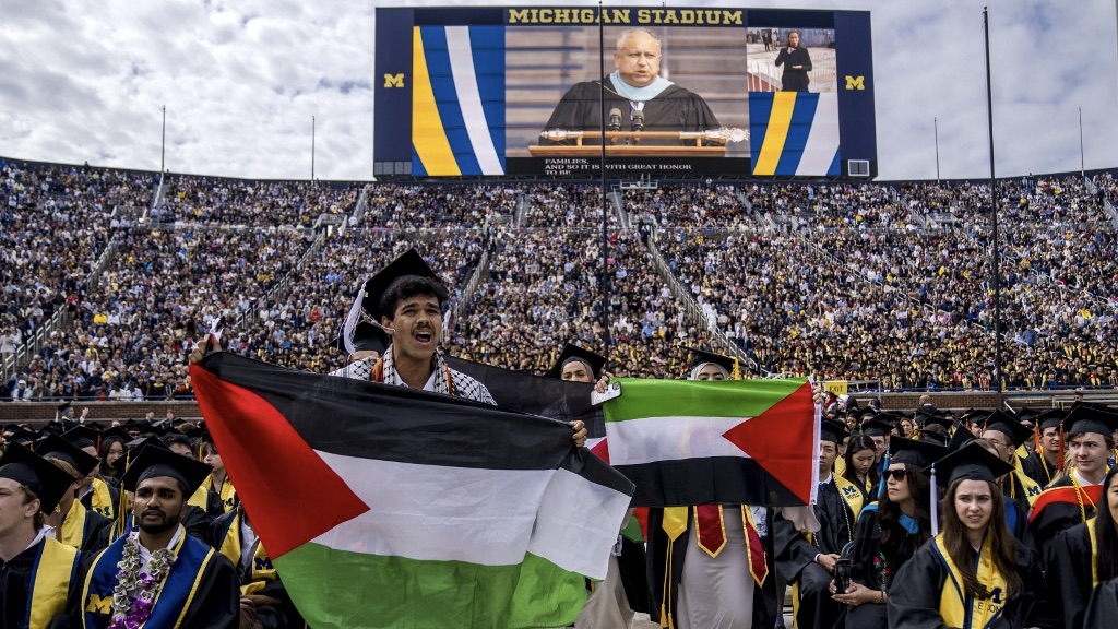 Students protest in support of Palestine during the University of Michigan's Spring Commencement ceremony, Ann Arbor, Michigan, 4 May 2024 (Nic Antaya/Getty/AFP)