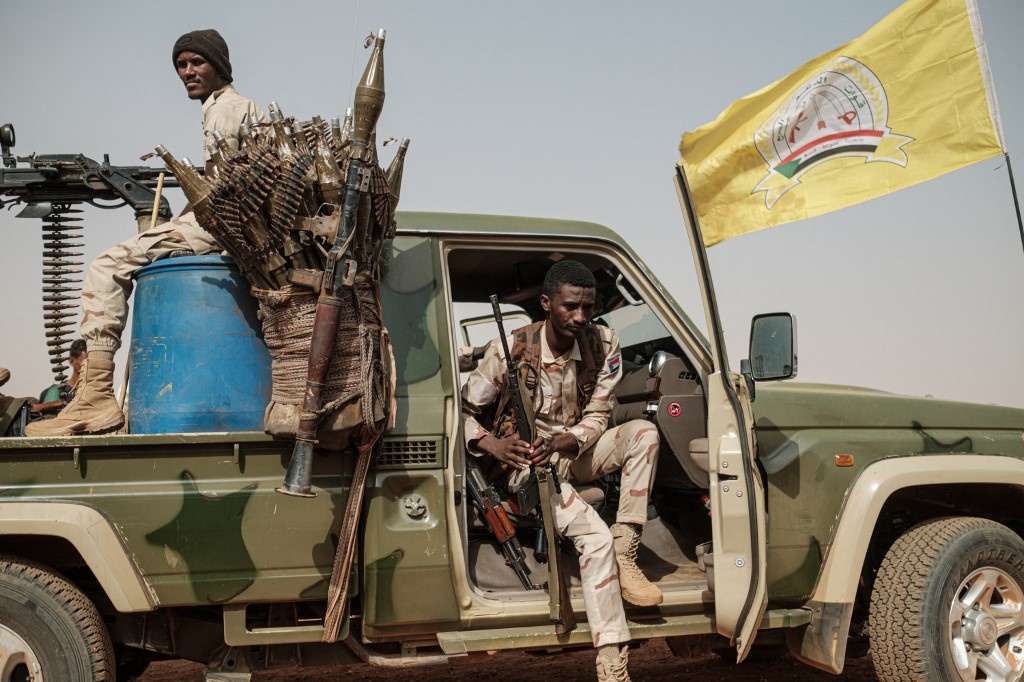 Members of the RSF paramilitaries secure the place for a rally for supporters of Sudan's ruling Transitional Military Council (TMC) in the village of Abraq, in June 2019 (Yasuyoshi Chiba/AFP)