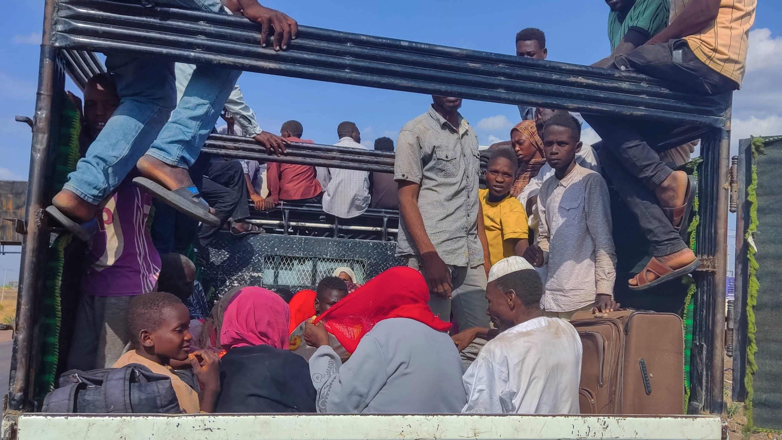 A photo taken on 30 June 2024 shows people fleeing the town of Singa, the capital of Sennar state, arriving in Gedaref in Sudan’s east (AFP)