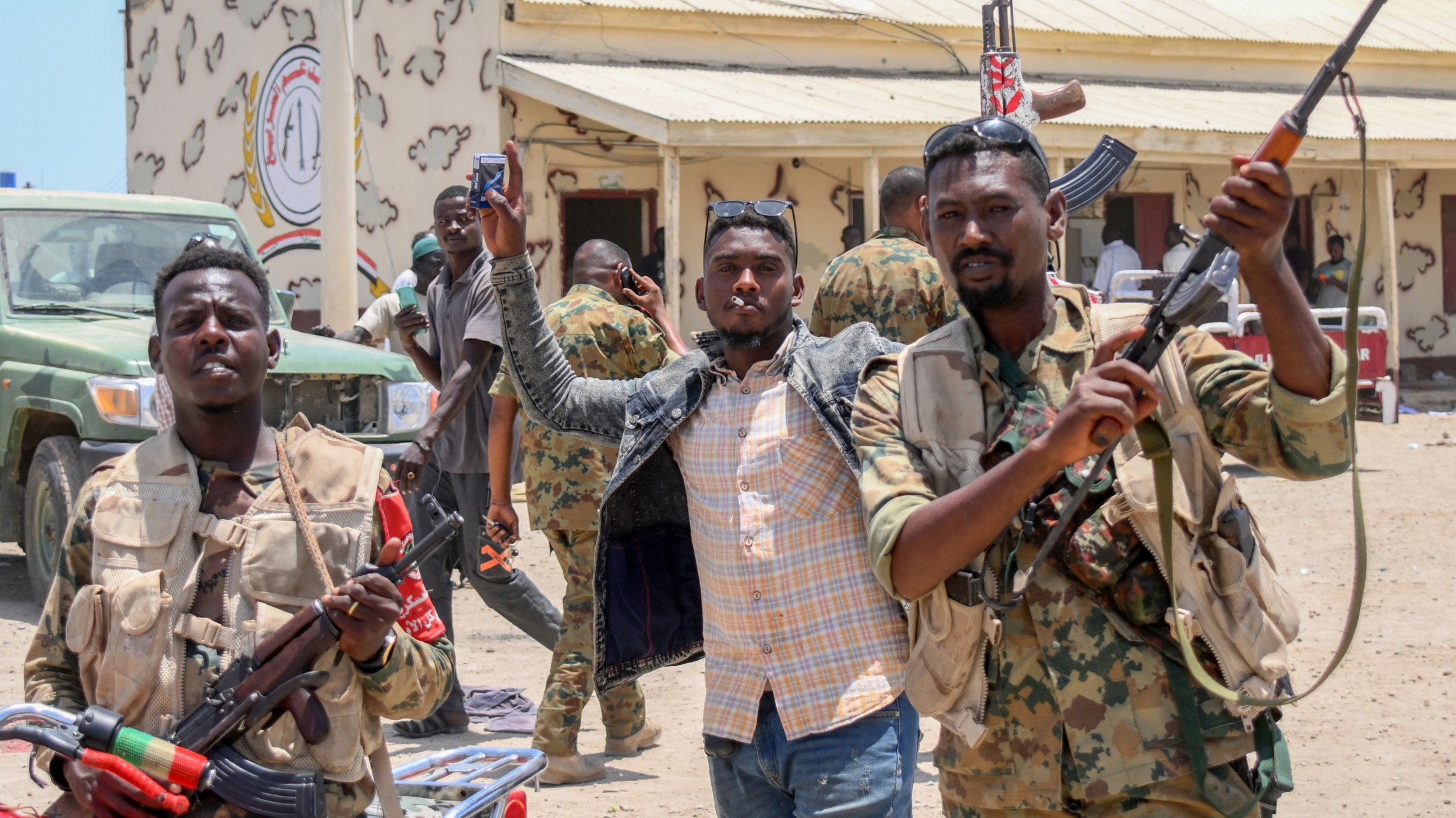 Sudanese army soldiers, loyal to army chief Abdel Fattah al-Burhan, posing for a picture at the Rapid Support Forces (RSF) base in city of Port Sudan, 16 April 2023 (AFP)