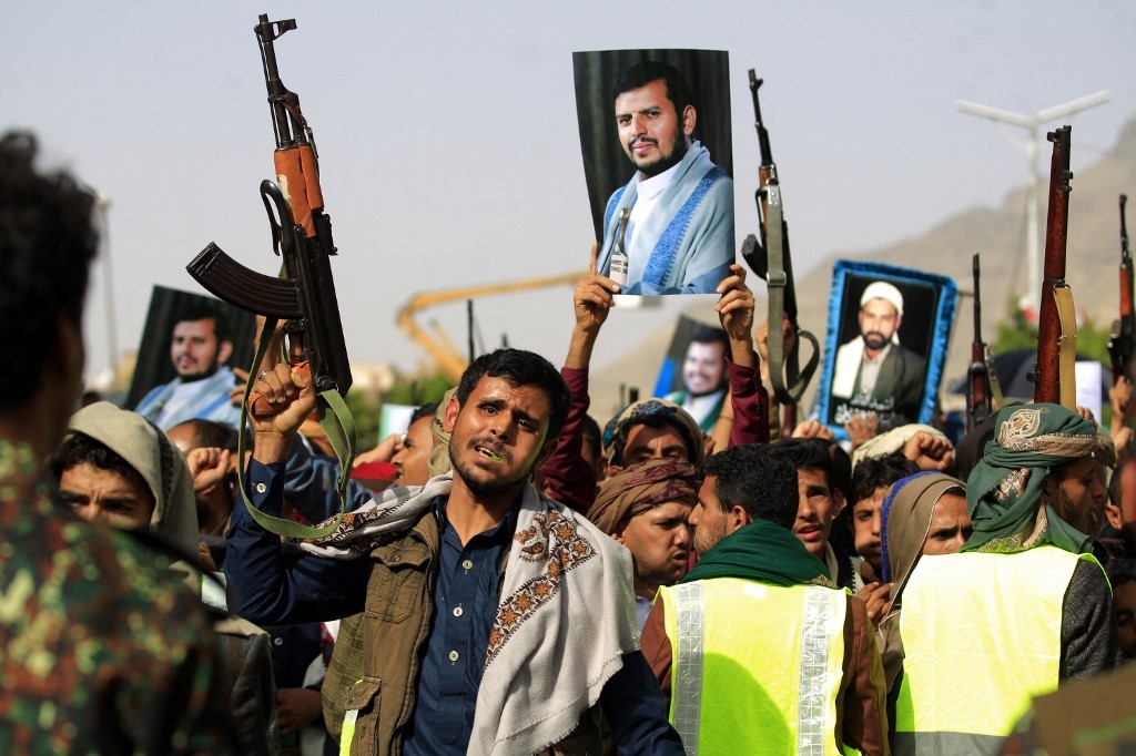 Supporters of Yemen's Houthi rebels raise portraits of their leader Abdul Malik al-Houthi during a rally in the capital Sanaa on 3 June 2022 (AFP)