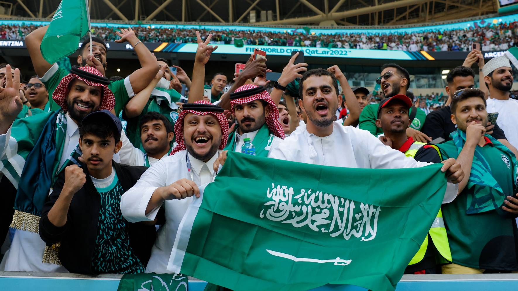 Saudi Arabia fans celebrate their team's victory over Argentina 2-1 during the Qatar 2022 World Cup football at Lusail Stadium, 22 November 2022 (AFP)