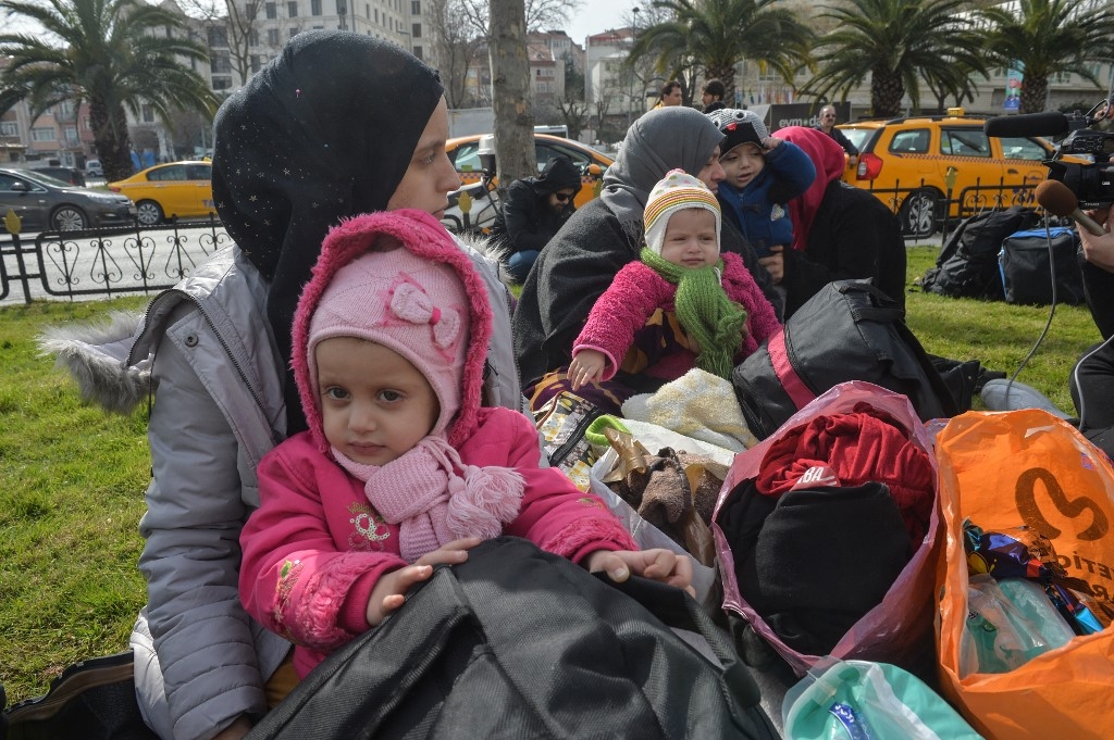 Syrian refugees wait to board a bus in Istanbul, as they head to the border villages in Edirne province on 28 February 2020 (AFP)