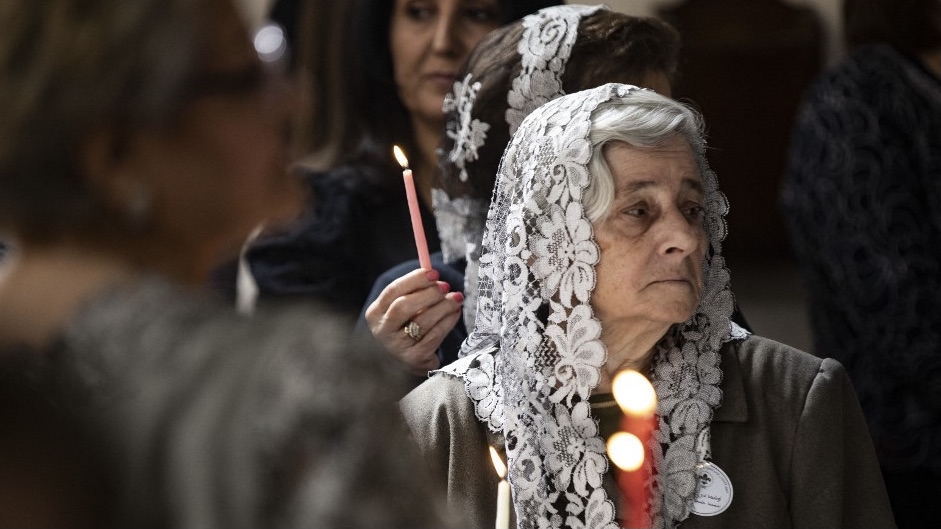 Syrian Christians attend a Palm Sunday mass at the Virgin Mary Syriac Orthodox Church in Qamishli, northeastern Syria, on 9 April 2023 (Delil Souleiman/AFP)