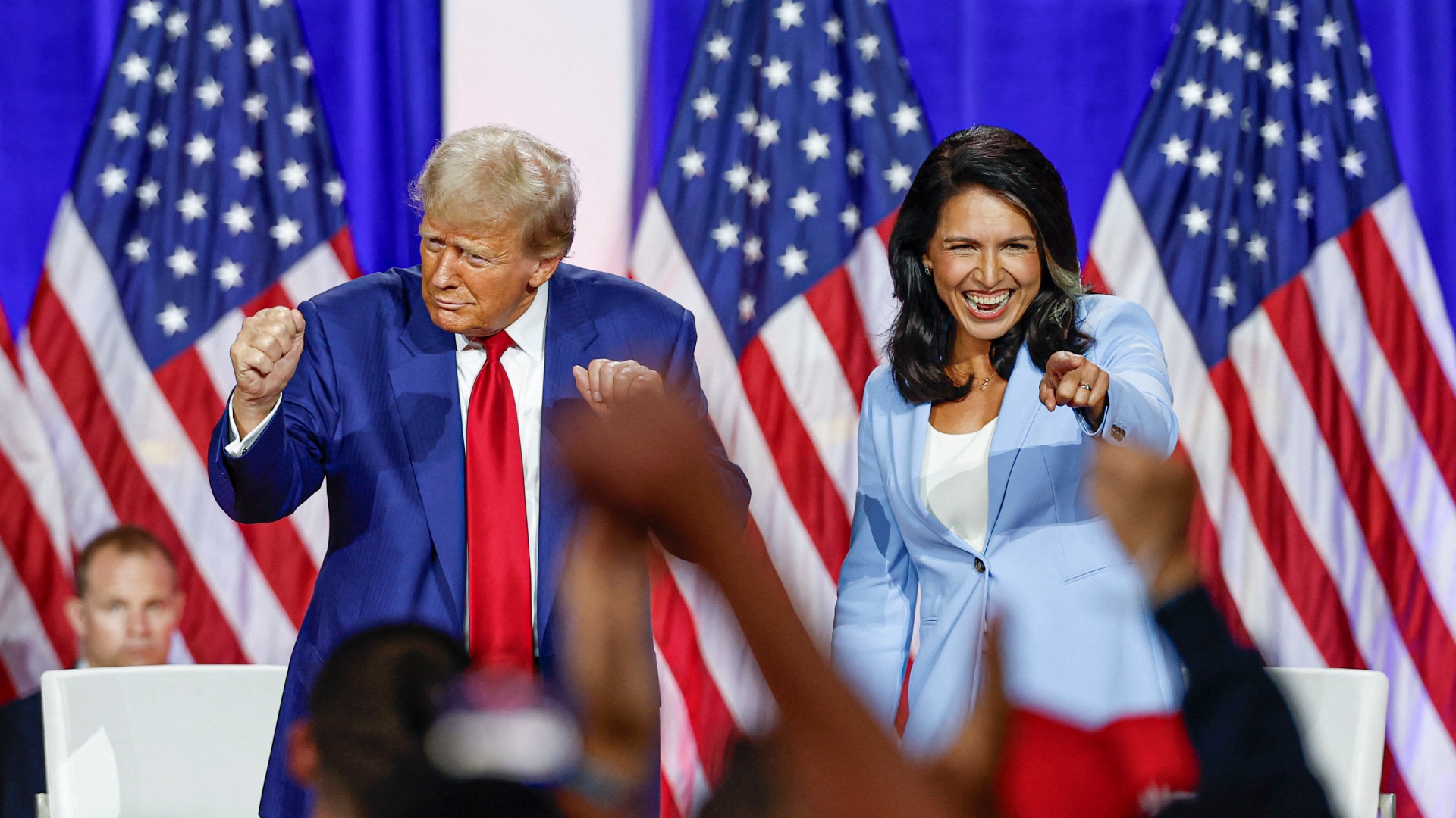 President-elect Donald Trump engages supporters after speaking alongside former US Representative Tulsi Gabbard, recently nominated as the director of national intelligence, during a campaign event in La Crosse, Wisconsin, on 29 August (Kamil Krzaczynski/AFP)