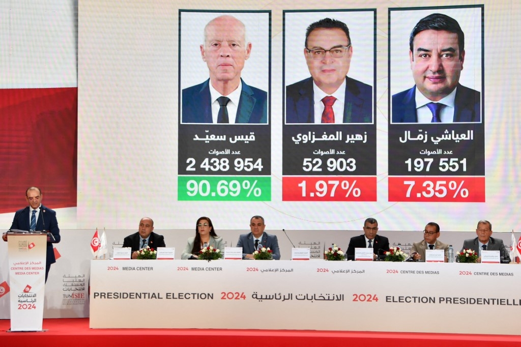 Farouk Bouasker, president of the Tunisian electoral body, announces the presidential elections results during a press conference in Tunis on 7 October (Fethi Belaid/AFP)