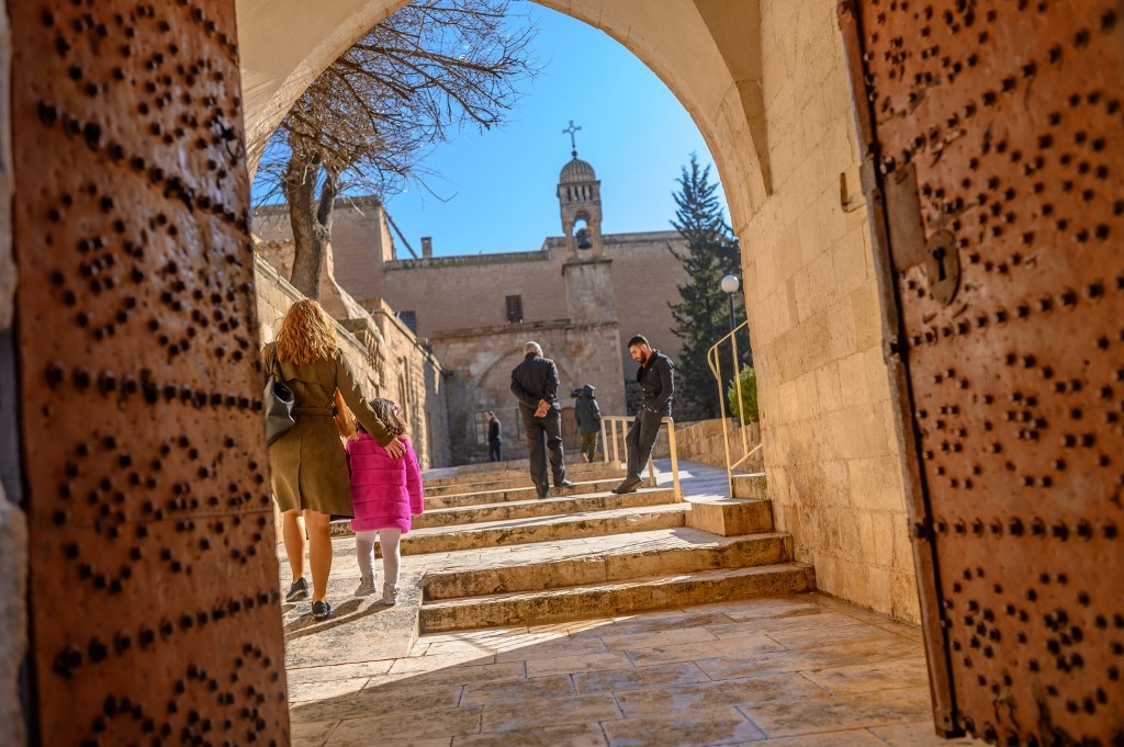 In this photograph taken on 23 February 2020, members of the Assyrian Christian community arrive to attend a Sunday mass at the More Benham Kirklar Church in Mardin, south-eastern Turkey (Bulent Kilic/AFP)