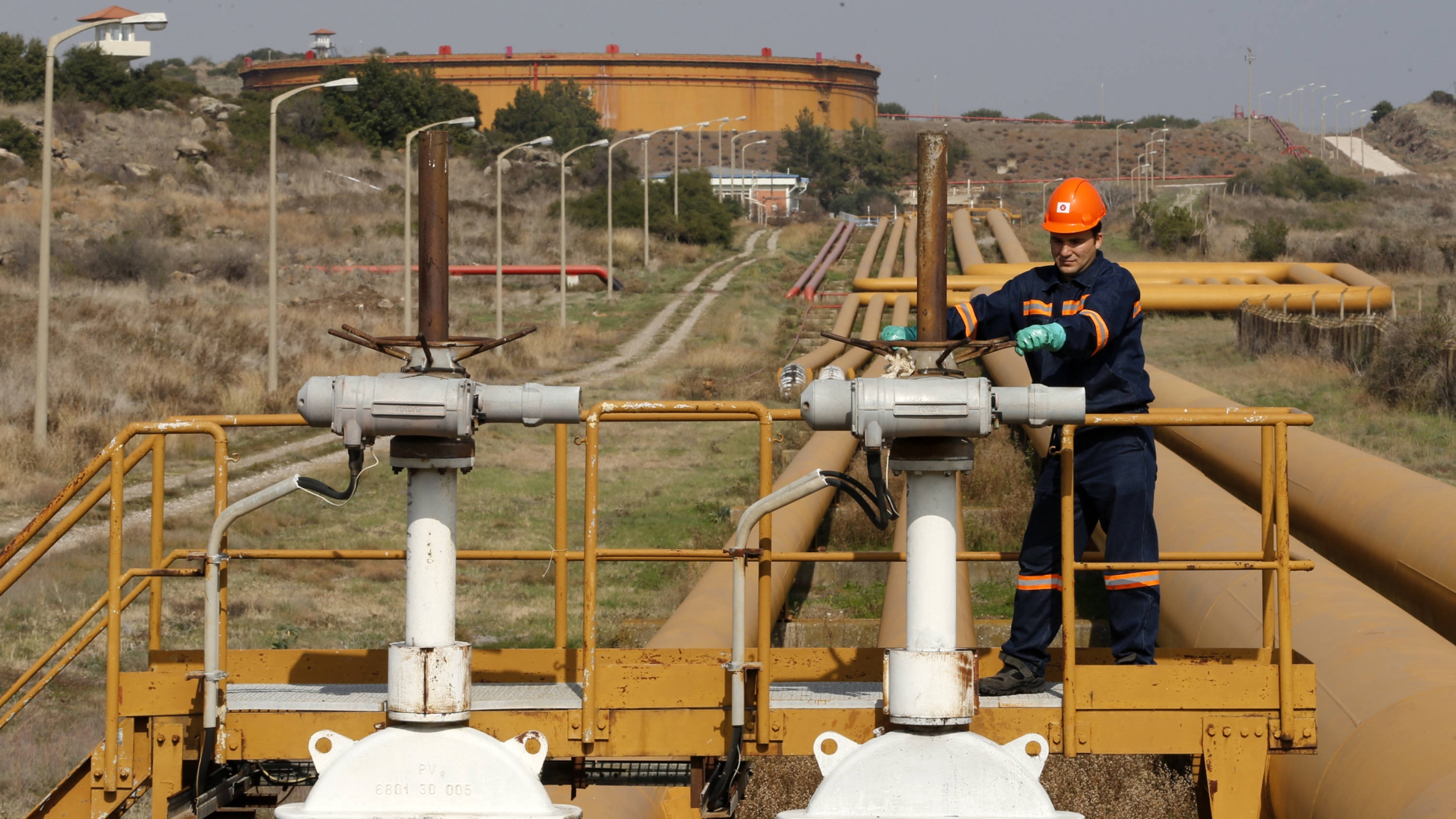 A worker checks the valve gears of pipes linked to oil tanks at Turkey's Mediterranean port of Ceyhan, which is run by state-owned Petroleum Pipeline Corporation