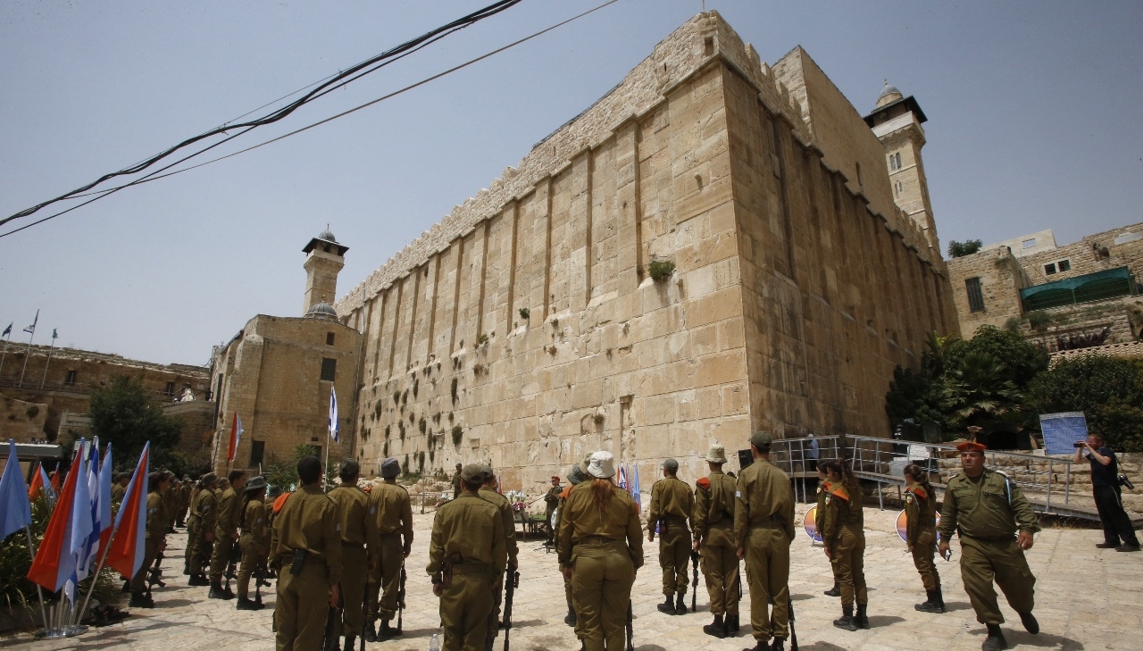 Israeli soldiers stand outside the Tomb of the Patriarchs, also known as the Ibrahimi Mosque