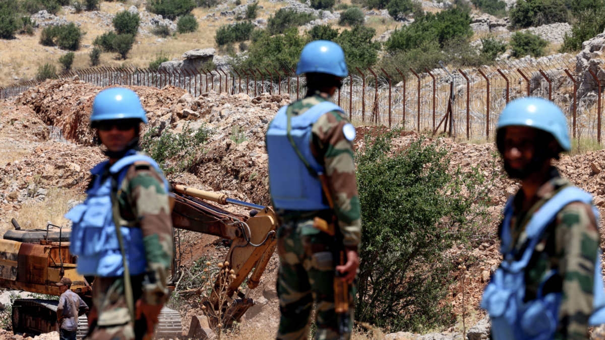 Soldiers from the UN Interim Forces in Lebanon stand along the barbed wire fence marking the border between Lebanon and Israel on 21 July 2023.