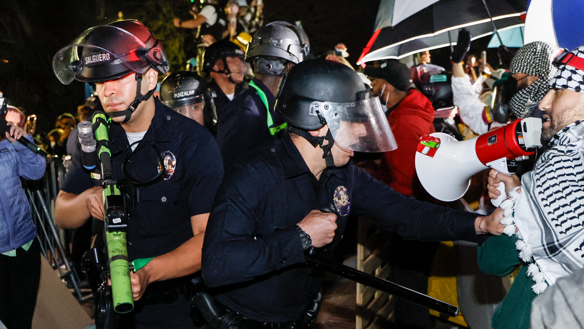 Police officers holding "less lethal" weapons cleared the UCLA pro-Palestine encampment on 2 May. AFP/Etienne Laurent.