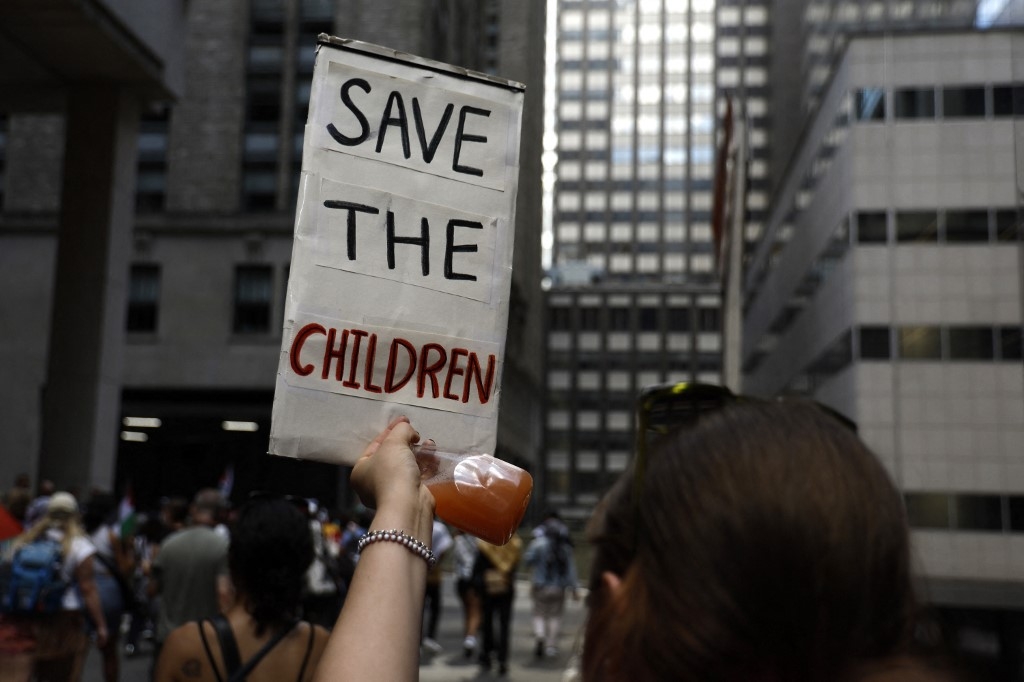 A demonstrator holds up a sign during a rally against the conflict in Gaza and the occupied West Bank on 2 September in New York City (John Lamparski/AFP) 