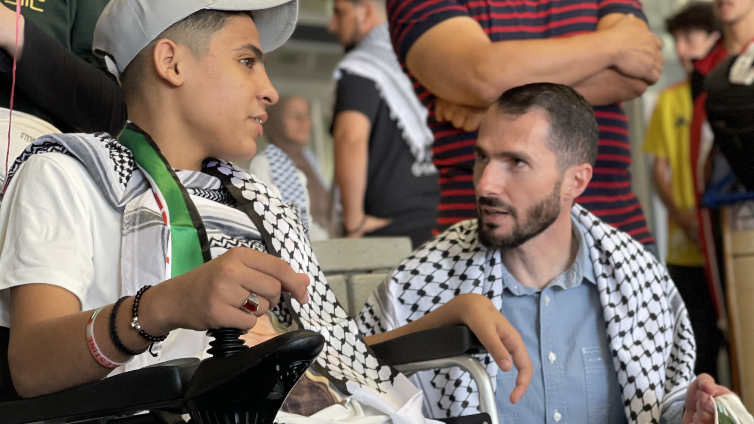 Ahmed, a 15-year-old Palestinian who lost both legs to Israeli bombing, converses with Dr Mohammad Subeh upon arriving in the US for treatment/Selina Chen