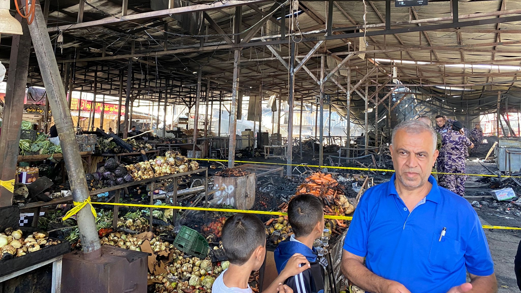 Palestinians check damage in the central vegetables market after an Israeli raid in Ramallah in the occupied West Bank 30 May 2024 (MEE/Majd Abu Rayya)