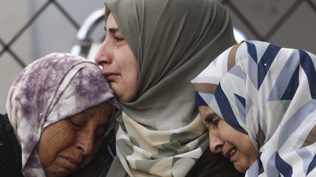 Women mourn relatives killed during an Israeli bombardment of al-Najar hospital in Rafah, on 12 February 2024 (Mohammed Abed/AFP)