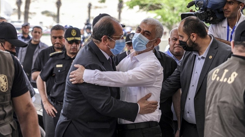 Hamas leader Yahya Sinwar (R) embraces Egypt's intelligence chief, General Abbas Kamel (L), as he arrives for a meeting with Hamas leaders in Gaza on 31 May 2021 (AFP/Mahmud Hams)