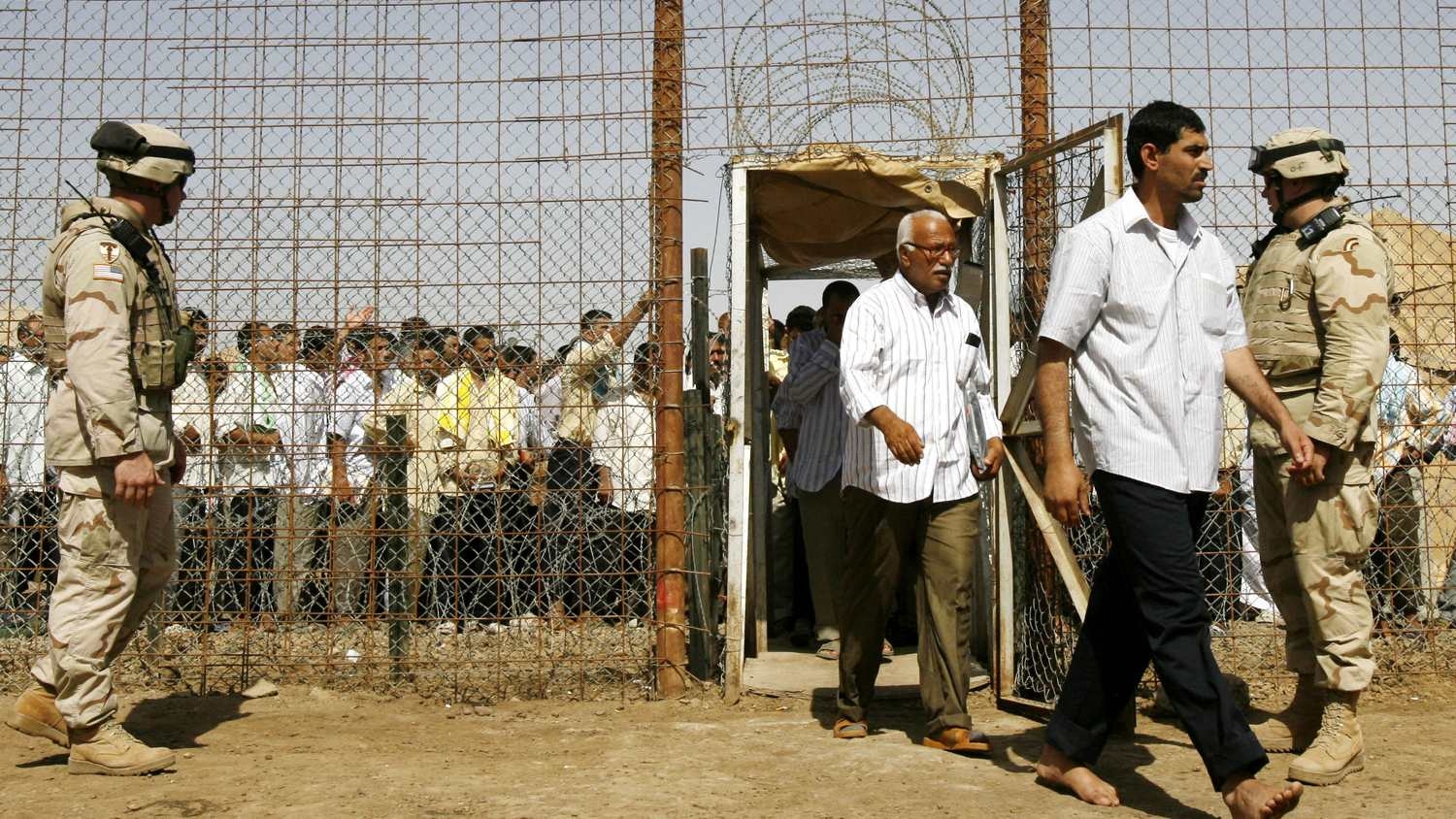 US soldiers stand on guard at the Abu Ghraib prison shortly before prisoners are released in Baghdad, on 15 June 2006.