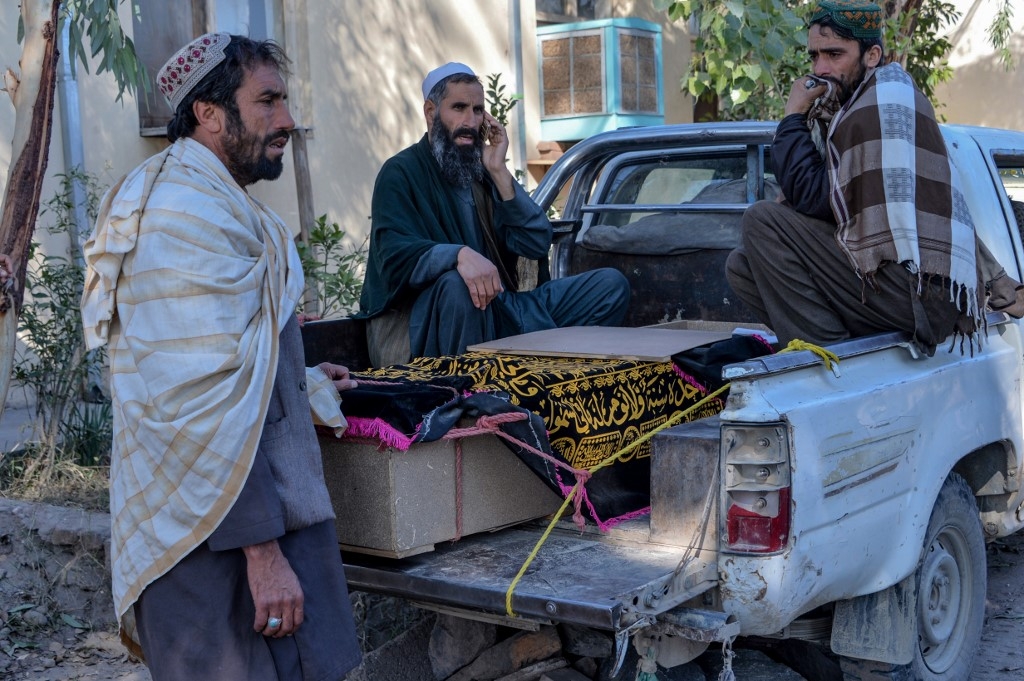 Relatives mourn next to the coffin of a victim who was killed during an air strike in Nangarhar province on 15 February 2020.