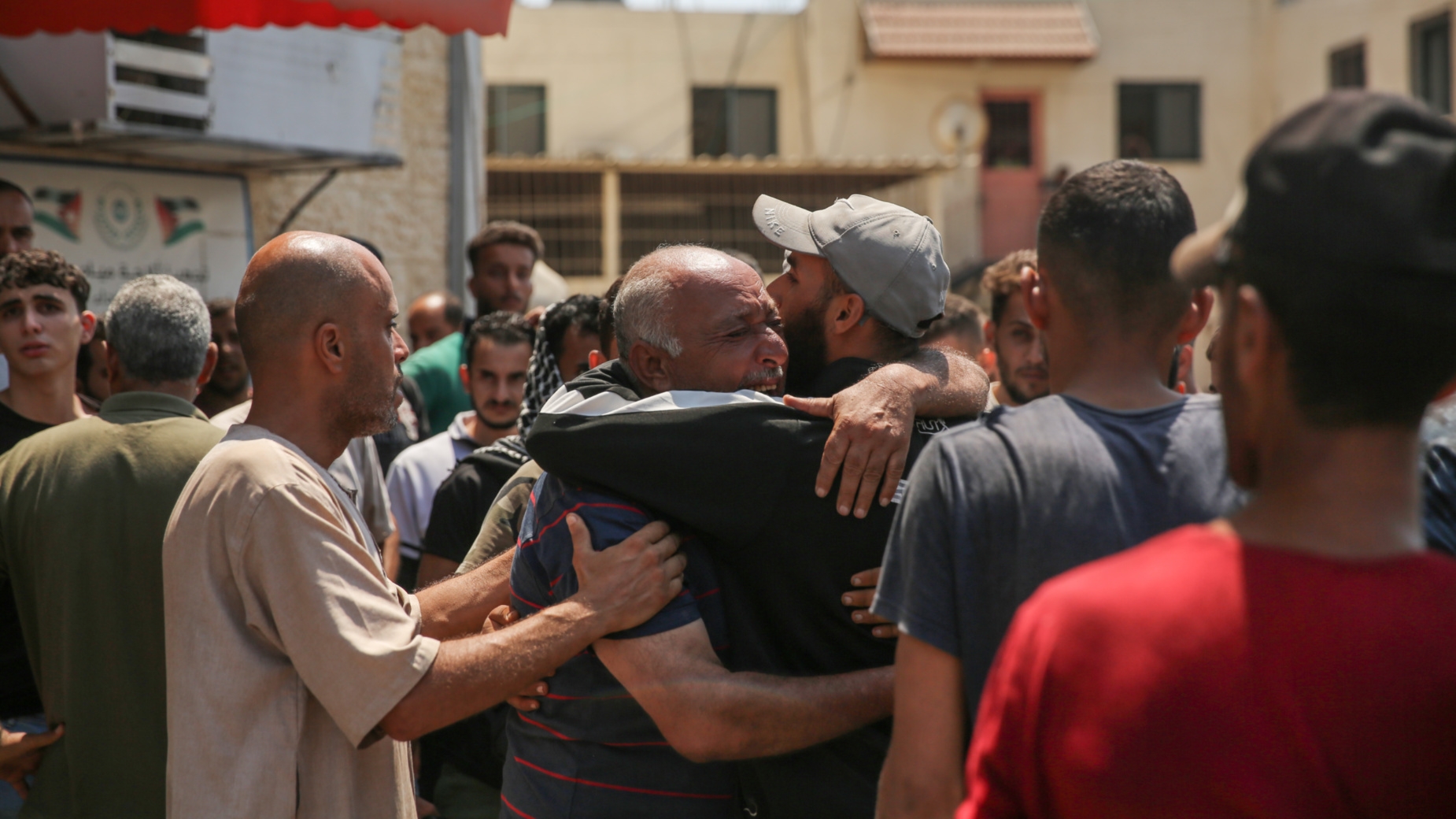 Palestinians react following a deadly Israeli strike on a school in Deir al-Balah, central Gaza on 27 July 2024 (Mohammed al-Hajjar/MEE)