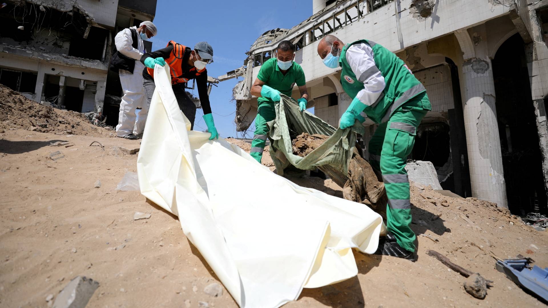 Rescuers and medics search for dead bodies inside the damaged al-Shifa Hospital after Israeli forces withdrew from the hospital and the area around it following a two-week operation in March (Reuters)