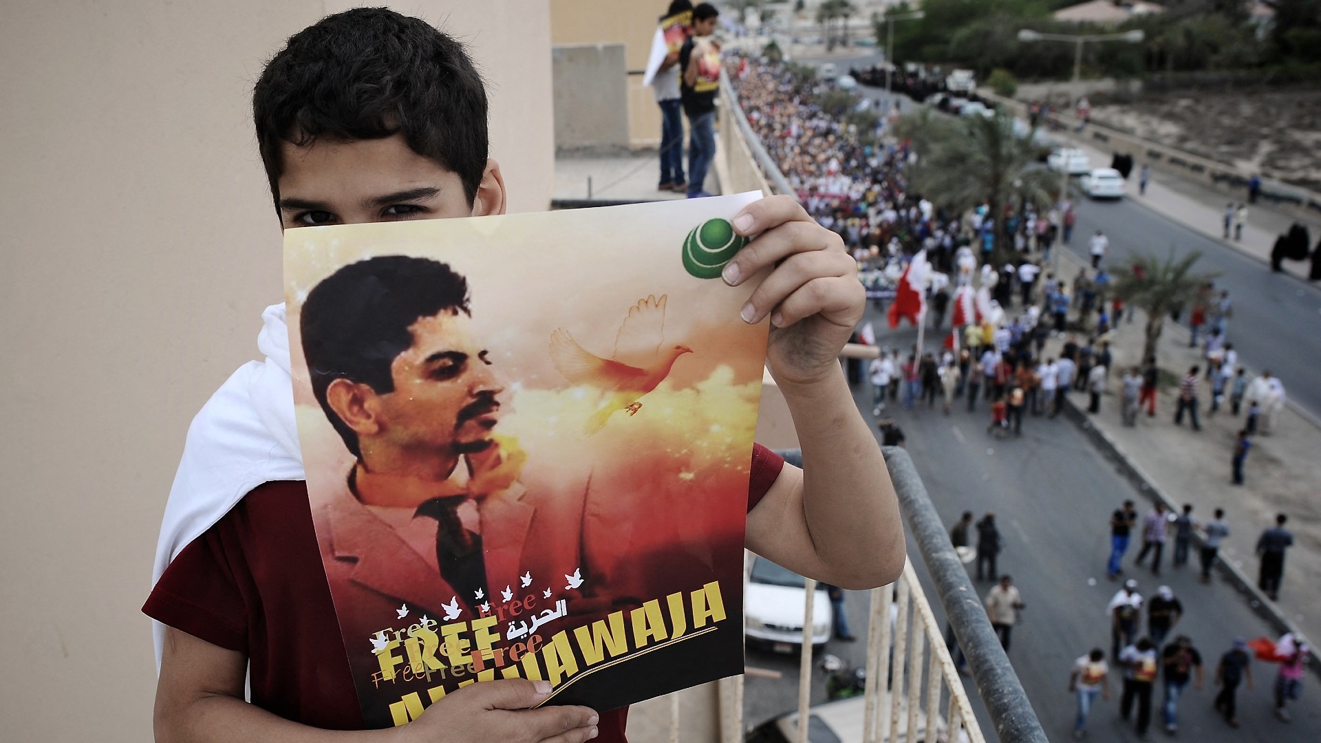 A Bahraini boy holds a poster of jailed activist Abdul-Hadi al-Khawaja during a protest calling for his release in the village of Jidhafs, west of Manama, on 6 April 2012 (AFP)