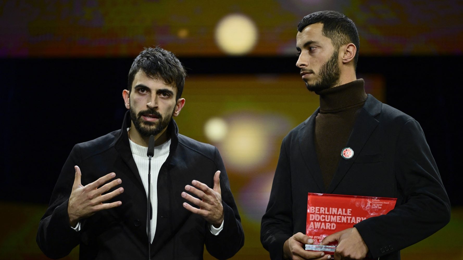 Yuval Abraham (right) delivers his award acceptance speech besides co-director Basel Adra (AFP/John Macdougall)