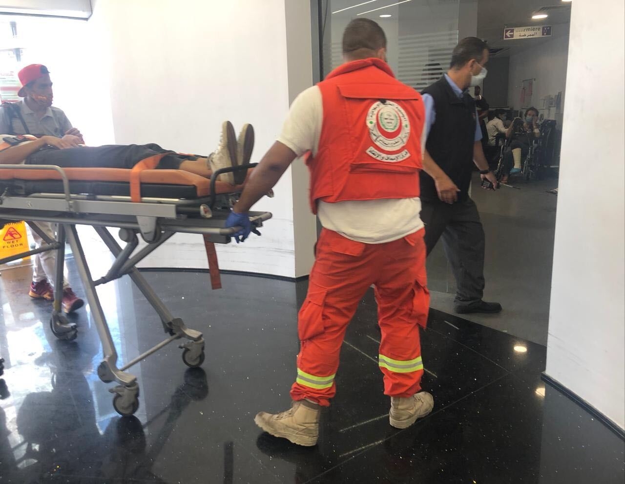 A patient carried on a stretcher at Hotel Dieu de France in Lebanon's Ashrafieh district