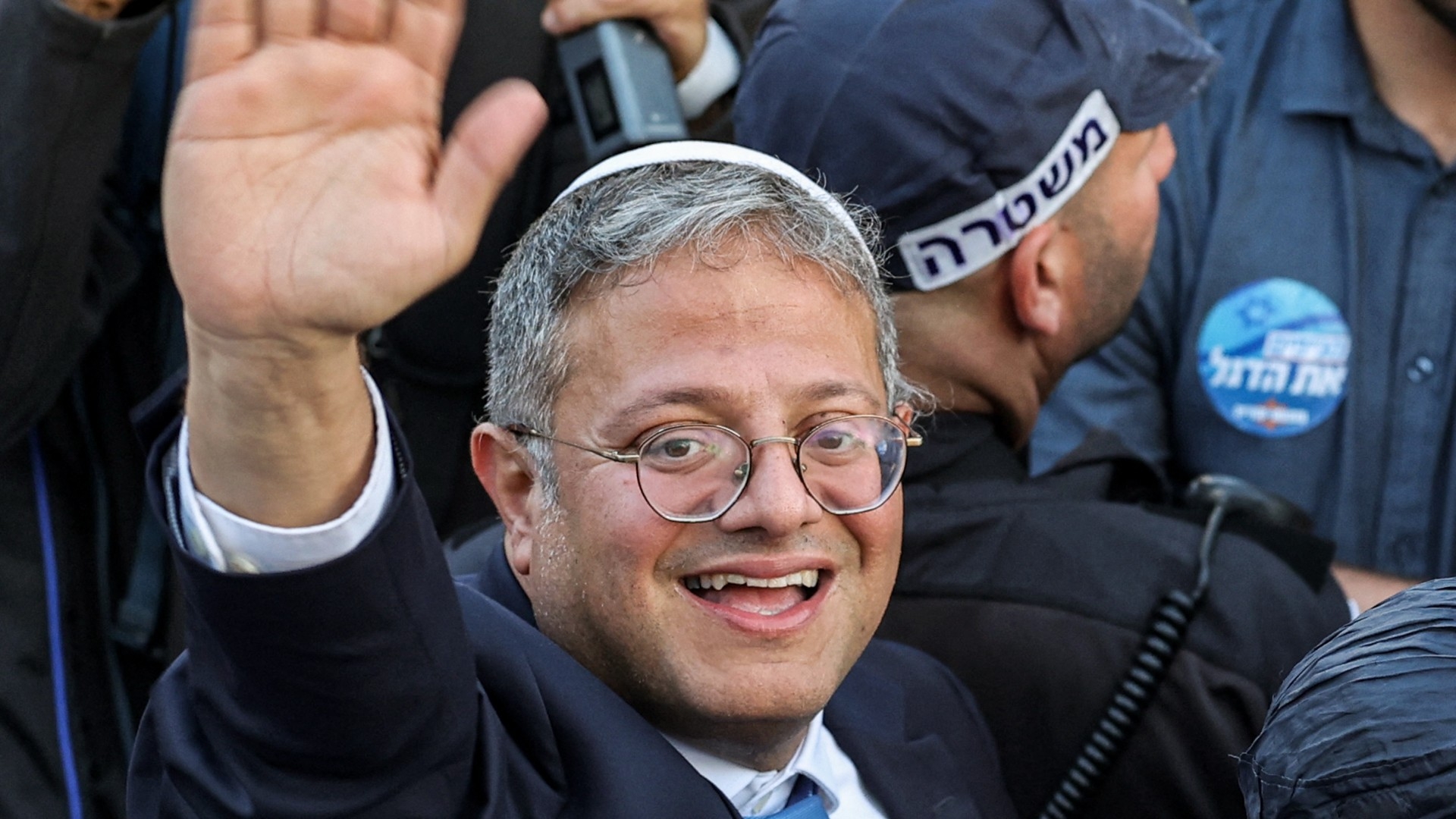 Israel's National Security Minister Itamar Ben-Gvir greets people gathering outside the Damascus Gate of the Old City of Jerusalem on 18 May, 2023 (AFP/Ahmad Gharabli)