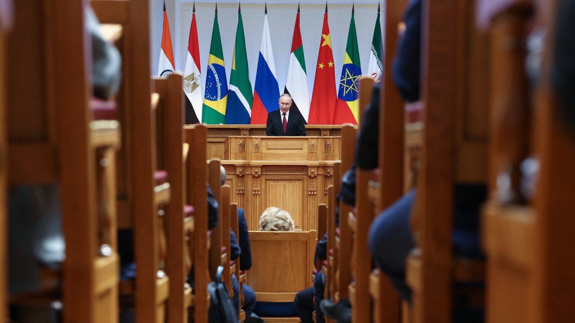 Russian President Vladimir Putin speaks at a Brics parliamentary forum in Saint Petersburg on 11 July (AFP)