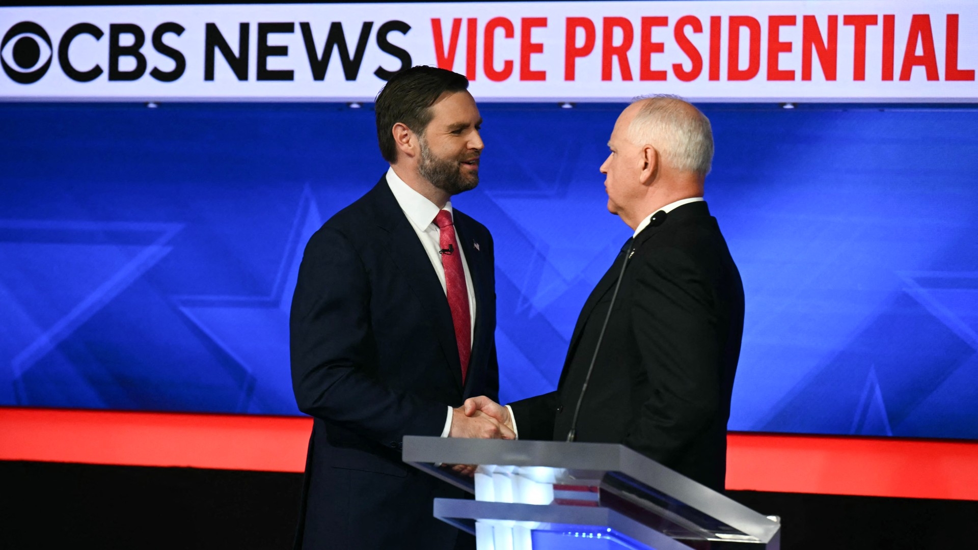 Democratic vice presidential candidate, Tim Walz, and Republican vice presidential candidate, Senator JD Vance, shake hands after a debate at CBS Broadcast Center, on 1 October 2024 in New York City (Angela Weiss/AFP)