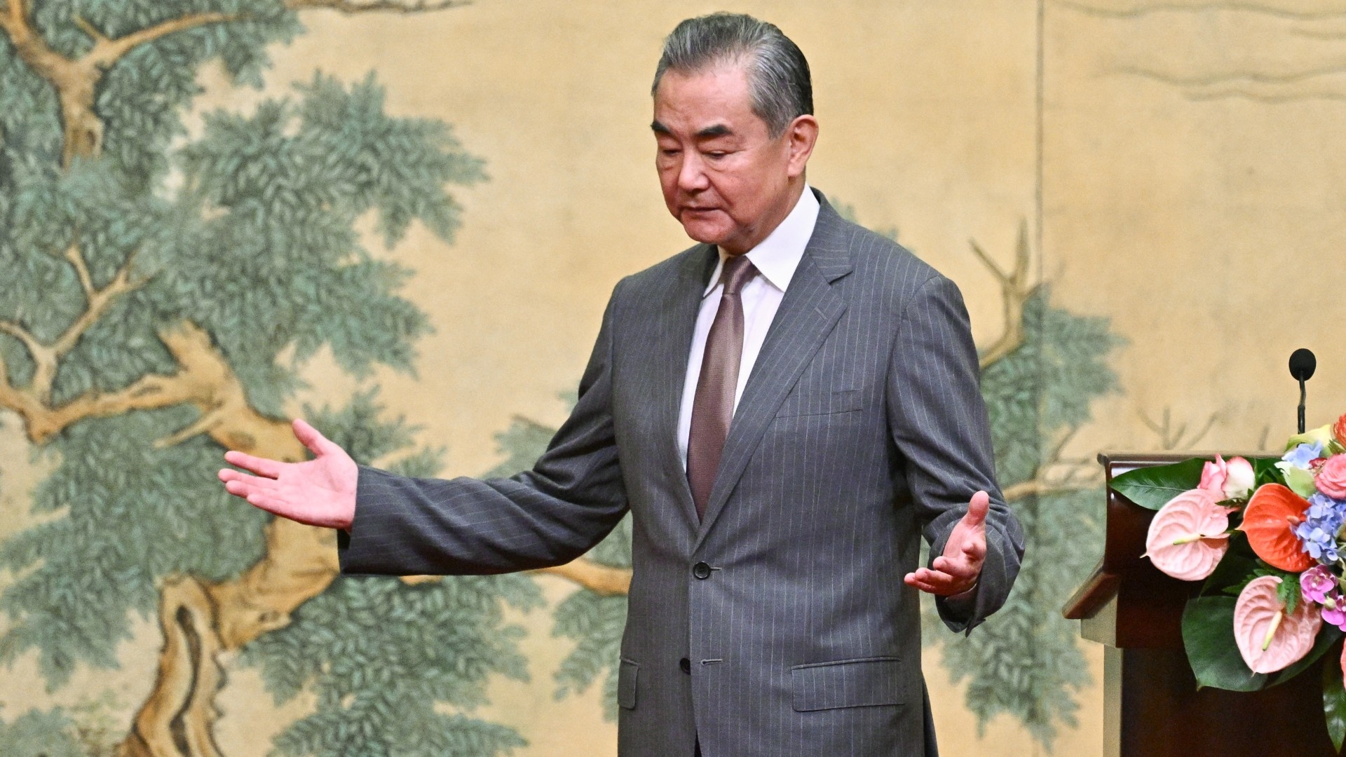 China's Foreign Minister Wang Yi gestures during an event hosting senior Palestinian officials in Beijing on 23 July 2024 (AFP/Pedro Pardo)