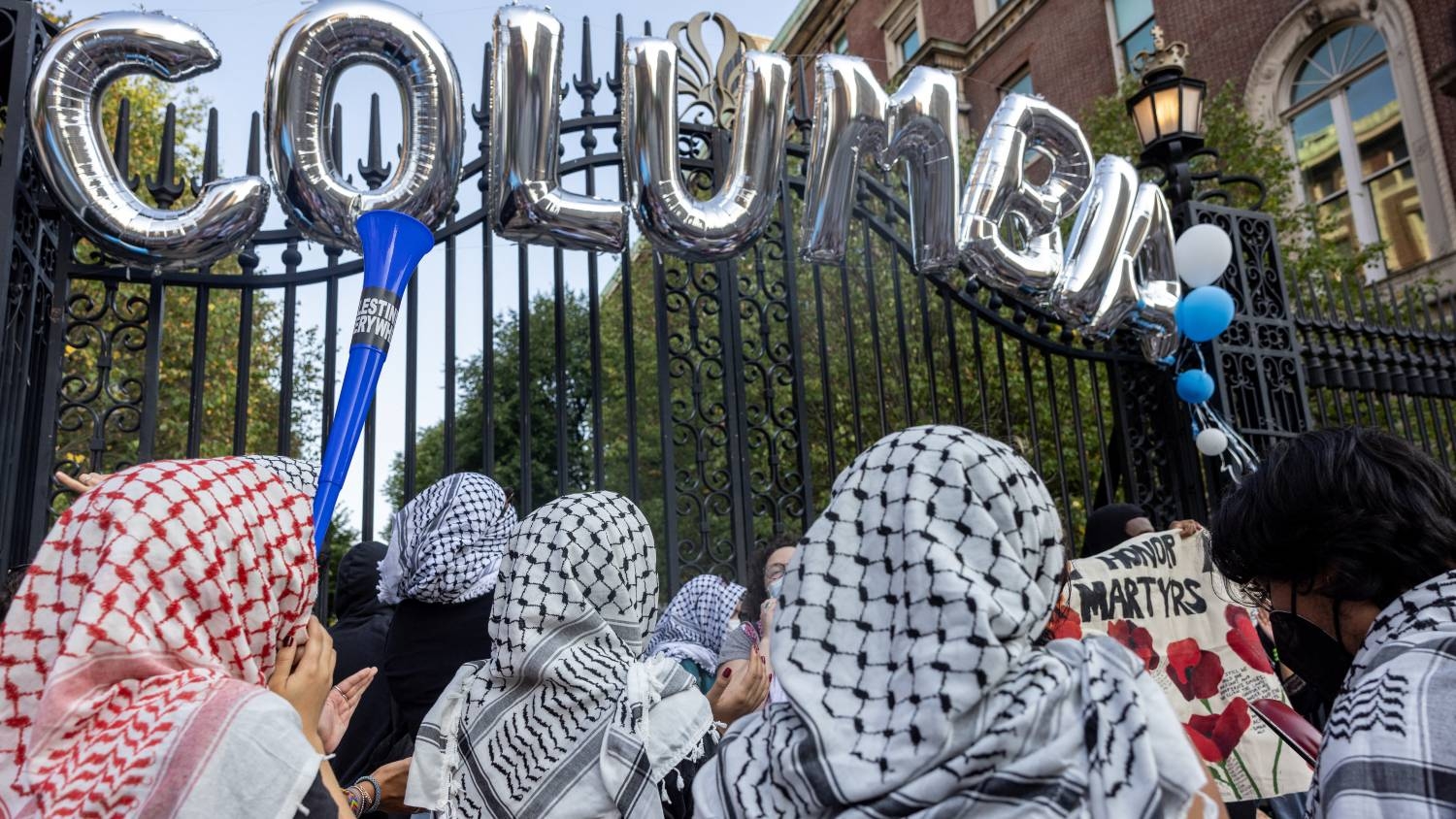 Protesters gather as students and families arrive for convocation, in front of a main gated entrance of Columbia University in New York City on 25 August 2024.