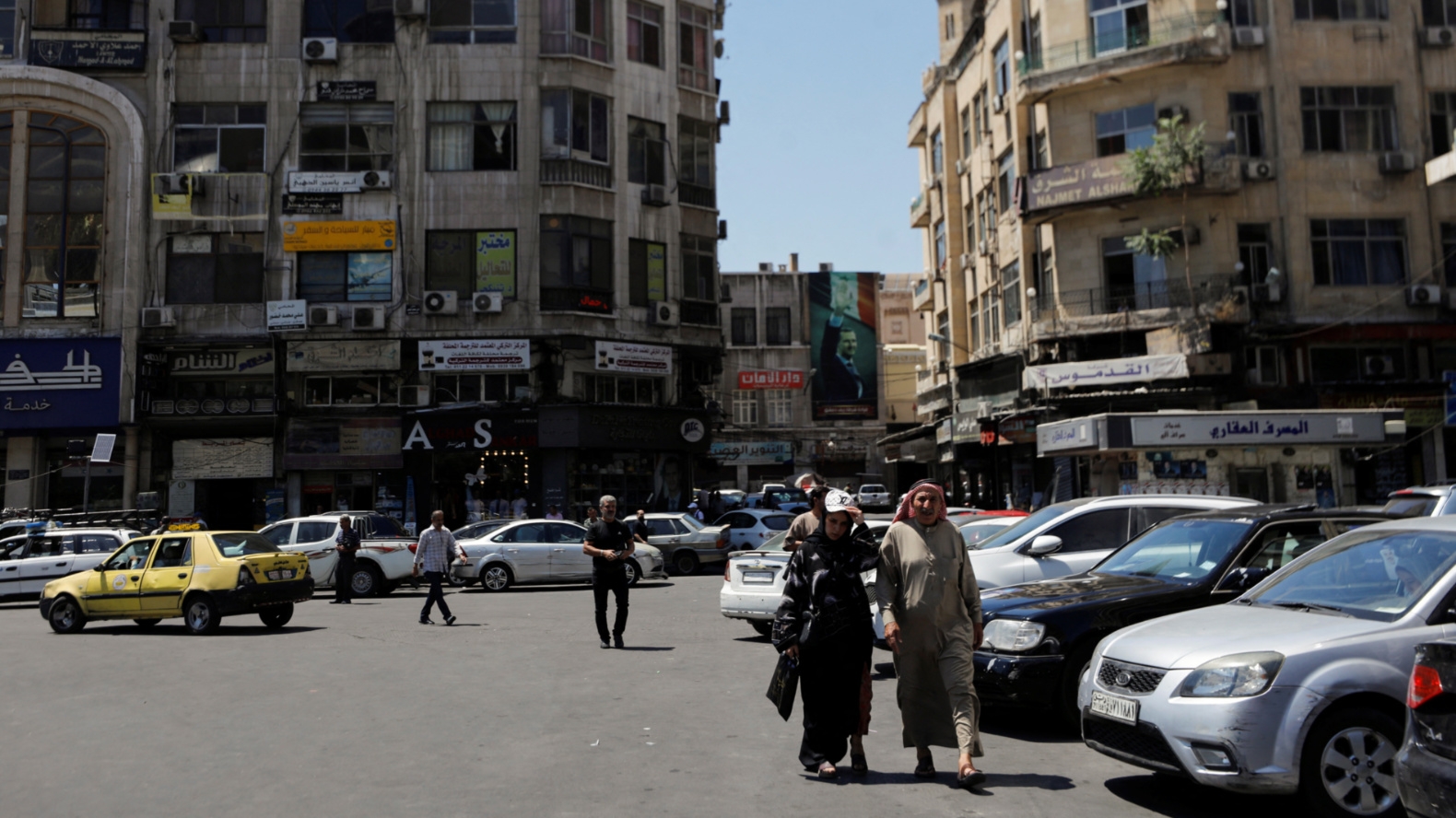 People walk in Damascus on the day of parliamentary elections on 15 July, 2024 (Yamam al-Shaar/Reuters)