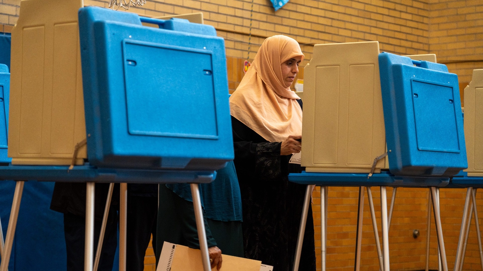 People vote inside McDonald Elementary School during election day in Dearborn, Michigan on 5 November (Reuters)