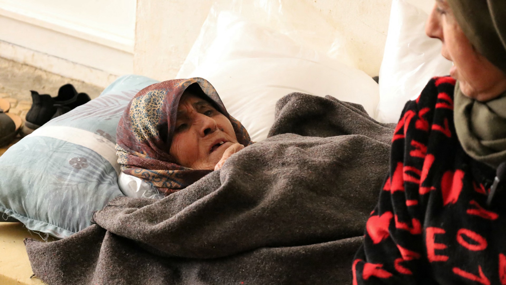 A displaced woman rests on a mattress in a school turned into a shelter in eastern Lebanon's Deir al-Ahmar on 1 November (AFP/Noor Habchy)