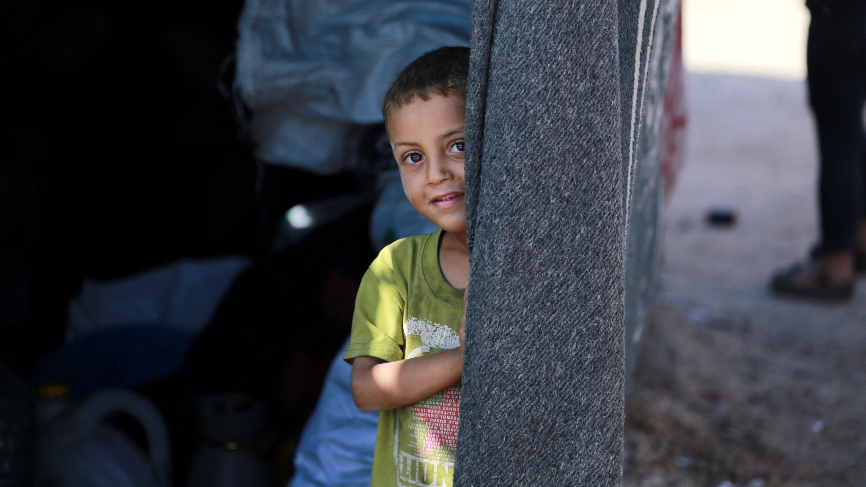 A boy inside a tent in the Deir al-Balah refugee camp in central Gaza on 11 June (AFP/Bashar Taleb)