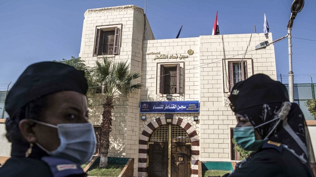 Egyptian police stand outside the entrance to al-Qanatir women's prison in Qalyoubiya province