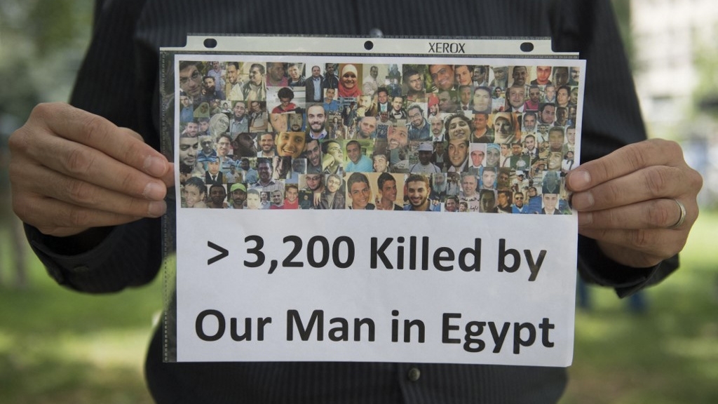 Demonstrators hold a rally in Washington, DC, to mark the one-year anniversary of Egypt’s Rabaa massacre, on 14 August 2014 (Saul Loeb/AFP)