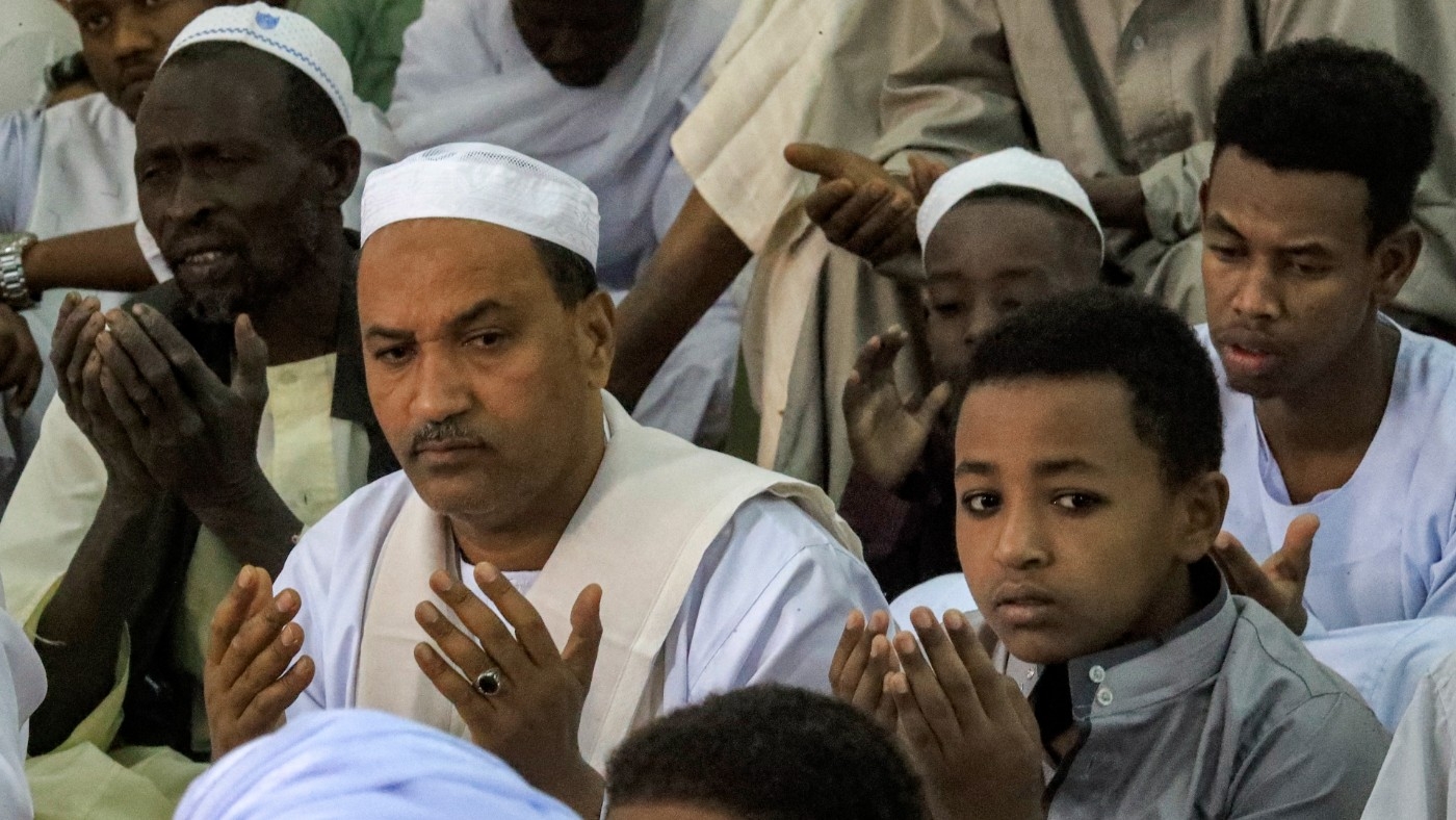 Muslim worshippers pray on the first day of Eid al-Fitr, which marks the end of the holy fasting month of Ramadan, at al-Hara al-Rabaa Mosque in the Juraif Gharb neighbourhood of Khartoum on 21 April 2023 (AFP)