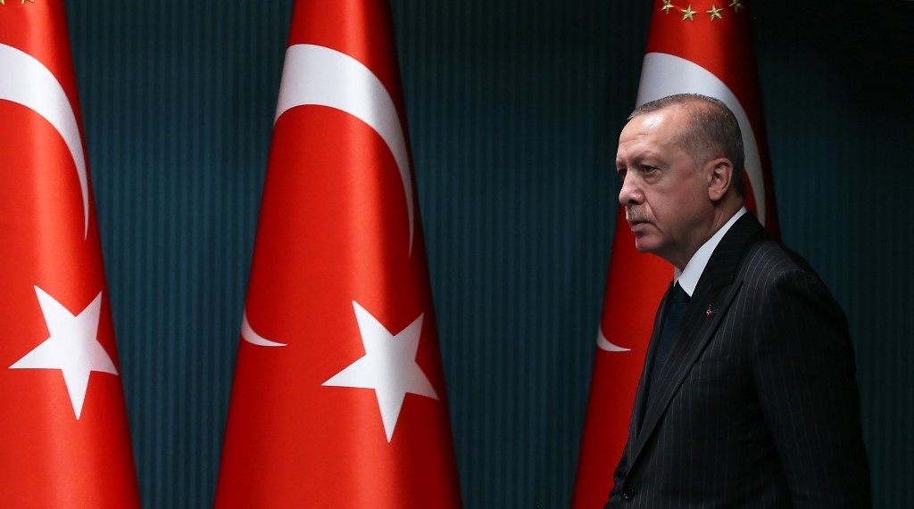 President Recep Tayyip Erdogan arrives for a news conference in Ankara