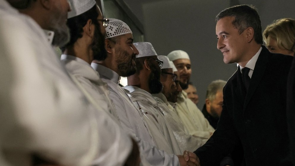 French Interior Minister Gerald Darmanin (R) meets with Imams as he arrives at Paris' Great Mosque for a wreath laying ceremony to commemorate Muslim soldiers who died for France, at Paris' Great Mosque on November 11, 2023.